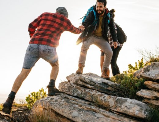 Men walking together and helping each other