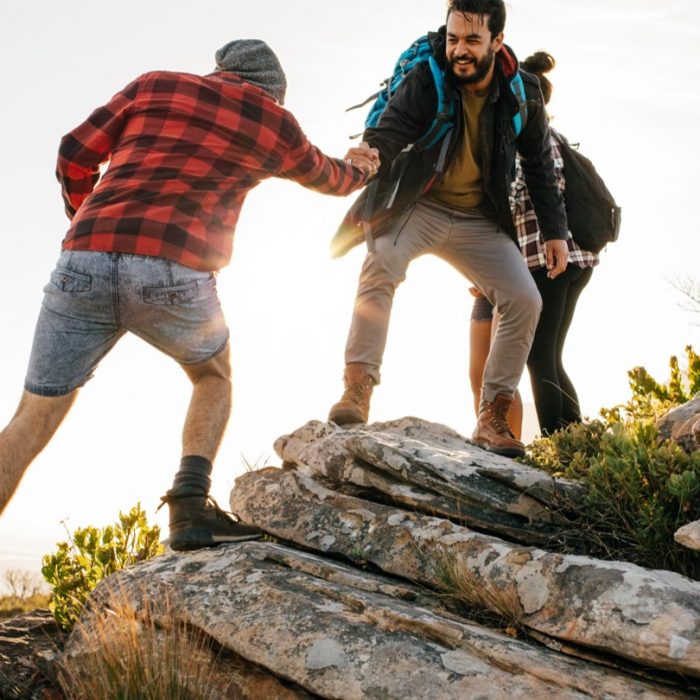 Men walking together and helping each other