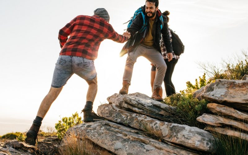 Men walking together and helping each other